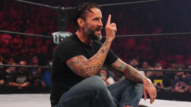 CM Punk sits in the ring delivering a promo